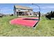 Backyard view of home with patio, sports court, and a manicured lawn at 4205 Hunt Club Pkwy, Bargersville, IN 46106