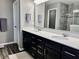 Modern bathroom with double vanity, stone countertop, mirrors and tiled shower at 4205 Hunt Club Pkwy, Bargersville, IN 46106