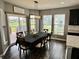 The dining room features hardwood floors, neutral walls, and large windows with a view of the backyard deck at 4205 Hunt Club Pkwy, Bargersville, IN 46106