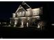 Elegantly lit two-story home exterior at night featuring stone accents and well-maintained landscaping at 4205 Hunt Club Pkwy, Bargersville, IN 46106