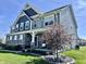 Striking two-story home featuring a stone facade, detailed trim, and a beautifully landscaped yard at 4205 Hunt Club Pkwy, Bargersville, IN 46106