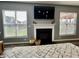 The living room fireplace is framed by large windows that provide natural light and neighborhood views at 4205 Hunt Club Pkwy, Bargersville, IN 46106
