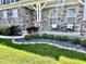 Charming front porch with stone accents, seating, and manicured landscaping at 4205 Hunt Club Pkwy, Bargersville, IN 46106