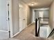 Carpeted hallway leading to the stairs with a railing and multiple closed doors at 4205 Hunt Club Pkwy, Bargersville, IN 46106