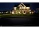 Beautifully illuminated two-story home at night with manicured lawn and inviting facade at 4205 Hunt Club Pkwy, Bargersville, IN 46106