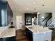 Bright kitchen with stainless steel appliances, island seating, and dark wood cabinets at 4205 Hunt Club Pkwy, Bargersville, IN 46106