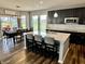 Modern kitchen features dark cabinets, stainless appliances, granite counters and breakfast bar with seating at 4205 Hunt Club Pkwy, Bargersville, IN 46106