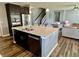 Open concept kitchen featuring stainless steel appliances, kitchen island with seating and wood floors at 4205 Hunt Club Pkwy, Bargersville, IN 46106