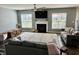 Comfortable living room featuring wood floors, a shaggy rug, a fireplace, and large windows for natural light at 4205 Hunt Club Pkwy, Bargersville, IN 46106