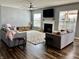 Cozy living room with neutral walls, wood floors, modern ceiling fan, and a fireplace with white mantle at 4205 Hunt Club Pkwy, Bargersville, IN 46106