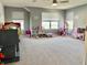 Spacious playroom featuring neutral walls, plush carpet, and ample natural light at 4205 Hunt Club Pkwy, Bargersville, IN 46106