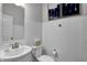 Well-lit half bathroom featuring white subway tile walls, a pedestal sink, and classic fixtures at 4249 Brocket Dr, Greenwood, IN 46143