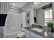 Bright bathroom featuring a shower-tub combo, a gray vanity, and ample natural light at 4249 Brocket Dr, Greenwood, IN 46143