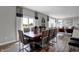 Well-lit dining room with a wooden table and direct access to the kitchen and living room at 4249 Brocket Dr, Greenwood, IN 46143