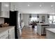Bright, modern kitchen with white cabinetry, stainless steel appliances, and an island overlooking the dining area at 4249 Brocket Dr, Greenwood, IN 46143