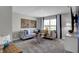 Comfortable living room with a gray sectional sofa, a round coffee table, and a bright window at 4249 Brocket Dr, Greenwood, IN 46143