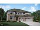 Charming two-story home boasts a brick and siding exterior with a two-car garage and a well-manicured lawn at 4302 Persian St, Greenwood, IN 46143