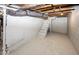 Unfinished basement with painted walls and stairs at 4325 Crittenden Ave, Indianapolis, IN 46205