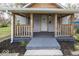 Inviting covered front porch with wooden railings, perfect for relaxing outdoors at 4325 Crittenden Ave, Indianapolis, IN 46205