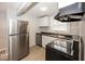 Modern kitchen with stainless steel appliances, sleek countertops, and ample storage at 4325 Crittenden Ave, Indianapolis, IN 46205