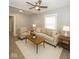 Bright living room featuring a ceiling fan, neutral decor, and ample natural light at 4325 Crittenden Ave, Indianapolis, IN 46205