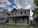 Two-story duplex with gray siding, broken windows, and a shared front porch, needs renovation at 433 Jefferson Ave, Indianapolis, IN 46201
