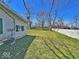 A spacious, green backyard with a white fence and mature trees creates a private outdoor oasis at 4520 Clinton St, Indianapolis, IN 46226