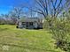 Exterior of house with lawn, trees and blue sky in background on a sunny day at 4520 Clinton St, Indianapolis, IN 46226