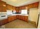 Cozy kitchen with wood cabinets and neutral countertops offering a functional space at 4520 Clinton St, Indianapolis, IN 46226