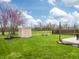 Spacious backyard featuring a storage shed, swing set, mature trees, and a fenced perimeter at 4729 Beach Club Dr, Noblesville, IN 46062