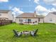 Large backyard with a fire pit area and a patio, perfect for outdoor entertainment and relaxation at 4729 Beach Club Dr, Noblesville, IN 46062