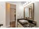 Bathroom featuring a vessel sink on granite counters, a framed mirror, and neutral gray walls at 4729 Beach Club Dr, Noblesville, IN 46062
