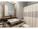 Bathroom showcasing a vessel sink on granite counters, a framed mirror, and a neutral shower curtain at 4729 Beach Club Dr, Noblesville, IN 46062