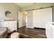 Bright Bedroom with a sliding barn door, dresser, and a comfortable rocking chair on laminate floors at 4729 Beach Club Dr, Noblesville, IN 46062