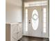 Entryway with dark laminate floors, a decorative front door, and a functional storage cabinet at 4729 Beach Club Dr, Noblesville, IN 46062