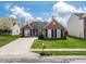 Charming brick home featuring a well-kept lawn, concrete driveway, and tidy landscaping at 4729 Beach Club Dr, Noblesville, IN 46062