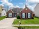 Charming brick home with a well-manicured lawn, blue door and shutters, and concrete driveway at 4729 Beach Club Dr, Noblesville, IN 46062