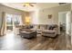 Bright living room with a large sectional sofa, wood floors, and natural light at 4729 Beach Club Dr, Noblesville, IN 46062