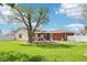 An ample backyard with a shade tree, concrete patio, and full white fence at 4905 Candy Spots Dr, Indianapolis, IN 46237