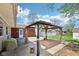 A brick home with a backyard that includes a gazebo with curtains for shade and privacy at 4905 Candy Spots Dr, Indianapolis, IN 46237