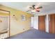 Inviting bedroom featuring a ceiling fan, a yellow wall, and an attached bathroom at 4905 Candy Spots Dr, Indianapolis, IN 46237