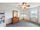 Cozy bedroom featuring a large window and a stylish dresser with a mirror at 4905 Candy Spots Dr, Indianapolis, IN 46237