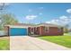 Beautiful brick home featuring a blue garage door and long driveway at 4905 Candy Spots Dr, Indianapolis, IN 46237