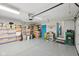 Organized garage space with epoxy floors, blue door, and overhead storage at 4905 Candy Spots Dr, Indianapolis, IN 46237