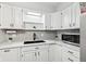 White cabinets, stainless steel appliances, and modern hardware accent this home's kitchen at 4905 Candy Spots Dr, Indianapolis, IN 46237