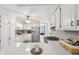 Bright kitchen with white cabinets, stainless appliances, gray subway tile and breakfast bar at 4905 Candy Spots Dr, Indianapolis, IN 46237