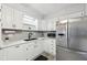 Bright kitchen featuring white cabinets, stainless steel appliances, and subway tile backsplash at 4905 Candy Spots Dr, Indianapolis, IN 46237
