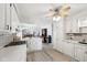 Bright, modern kitchen with white cabinets, stainless steel appliances, and wood-look flooring at 4905 Candy Spots Dr, Indianapolis, IN 46237