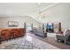 Open living room showcasing a wooden bar, vaulted ceiling, and contemporary furnishings at 4905 Candy Spots Dr, Indianapolis, IN 46237