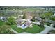 Aerial view of a home with a backyard pool, patio, mature trees, and a well-manicured lawn in a quiet neighborhood at 4977 Beechwood Rd, Avon, IN 46123